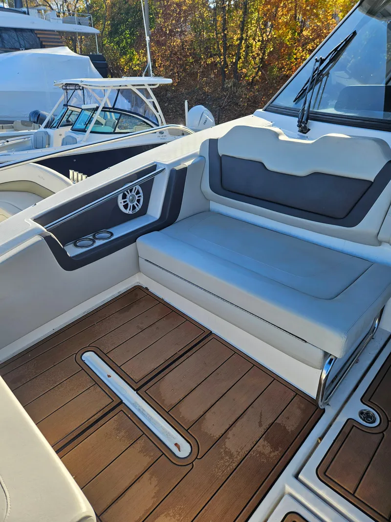 Slide: The Image of 2020 Aquila 36 Sport boat interior with cushioned seating and wooden deck. - 27