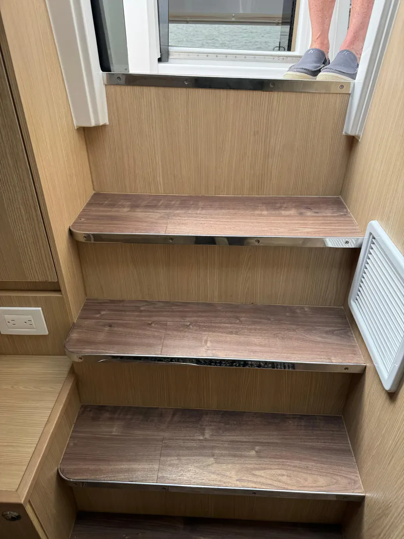 Slide: The Image of Wooden interior stairs in 2020 Aquila 36 Sport boat. - 31