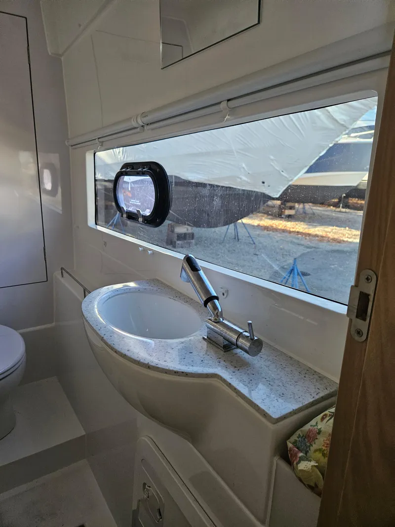 Slide: The Image of Modern bathroom interior of 2020 Aquila 36 Sport yacht with sink and window. - 38