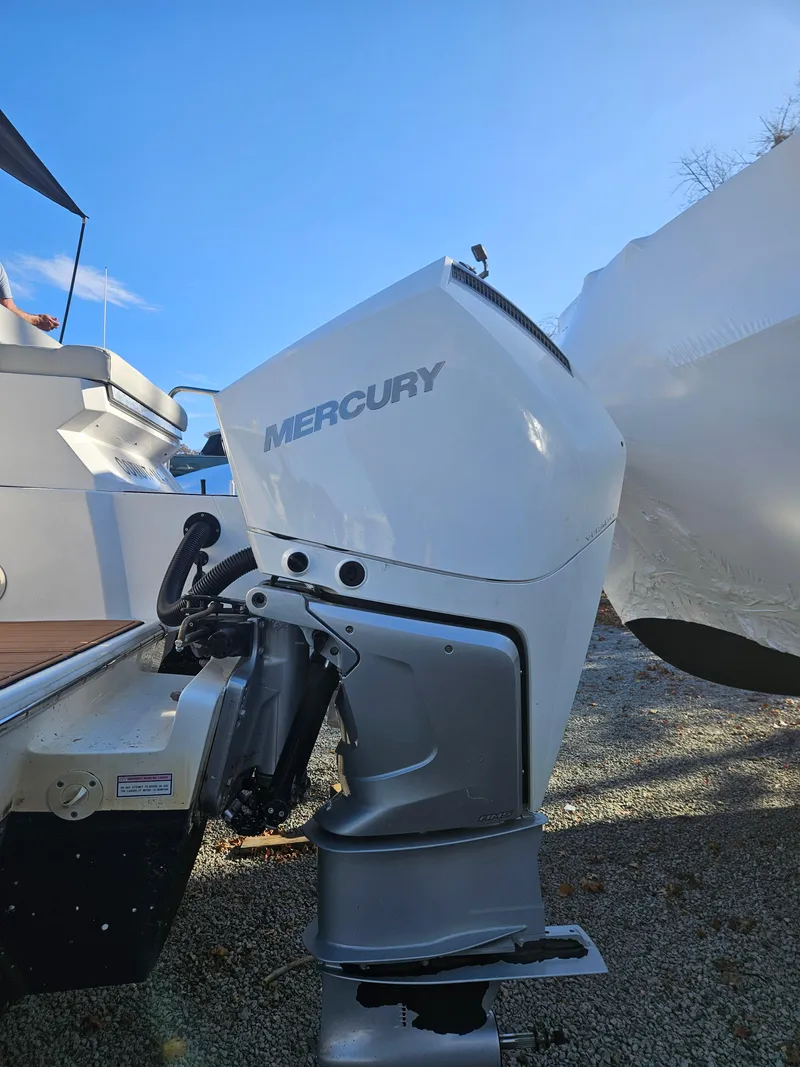 Slide: The Image of 2020 Aquila 36 Sport with Mercury outboard engine, docked under clear blue sky. - 47