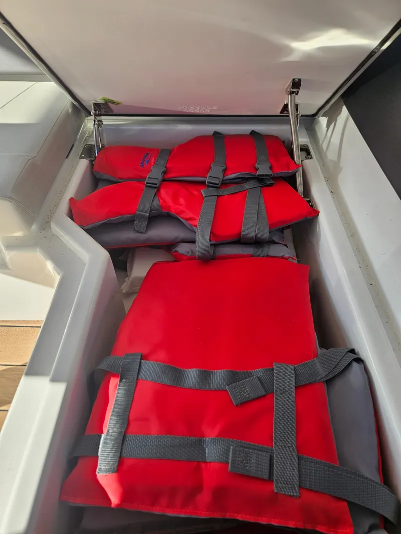 Slide: The Image of Red life jackets stored in an Aquila 36 Sport 2020 boat compartment. - 48