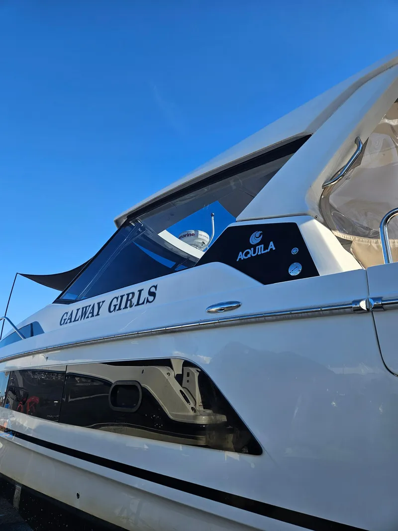 Slide: The Image of Aquila 36 Sport 2020 boat named "Galway Girls" under clear blue sky. - 7