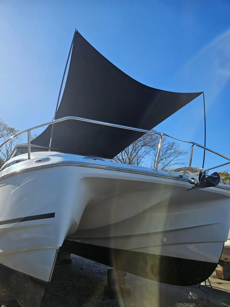 Slide: The Image of 2020 Aquila 36 Sport boat with sunshade, viewed from the front. - 8