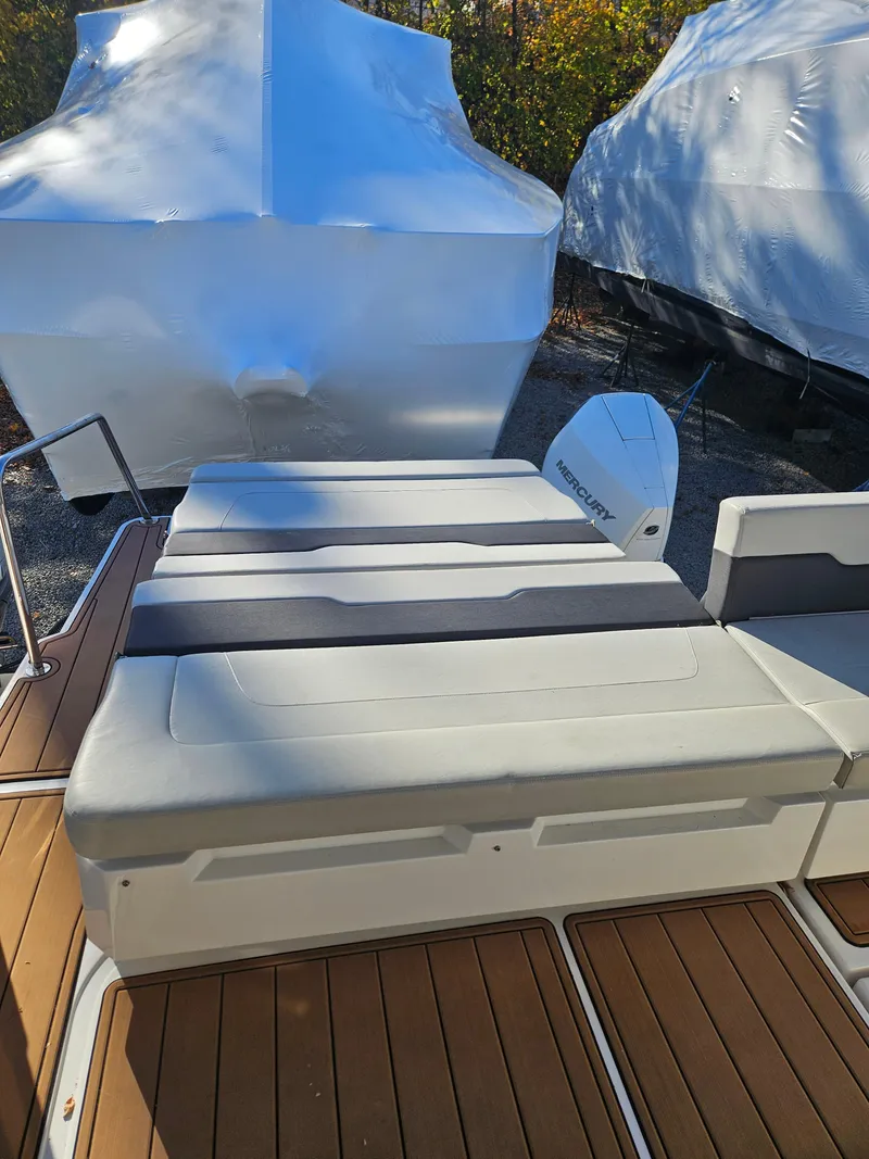 Slide: The Image of Aquila 36 Sport 2020 boat with cushioned seating and wooden deck. - 9