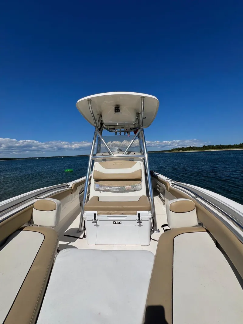 Slide: The Image of 2018 Pioneer 222 Islander boat on calm water under clear blue sky. - 5