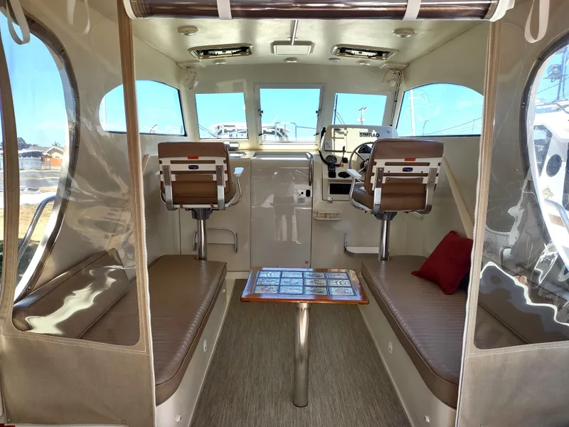Slide: The Image of Interior of 2008 Mainship 30 Pilot II Sedan with seating and helm. - 16