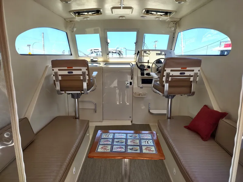Slide: The Image of Interior of 2008 Mainship 30 Pilot II Sedan with seating and helm. - 17