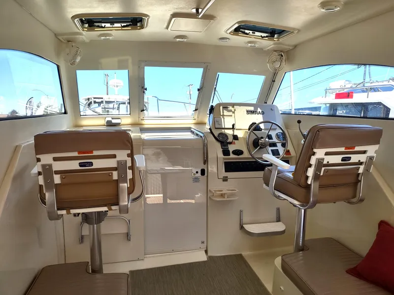 Slide: The Image of Interior of 2008 Mainship 30 Pilot II Sedan with helm and seating. - 19