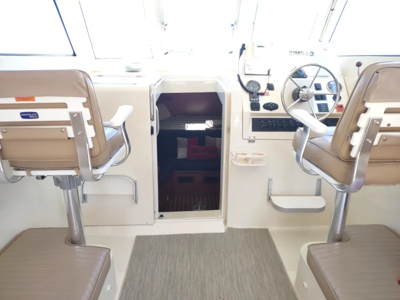 Slide: The Image of Interior of 2008 Mainship 30 Pilot II Sedan with helm and seating. - 20