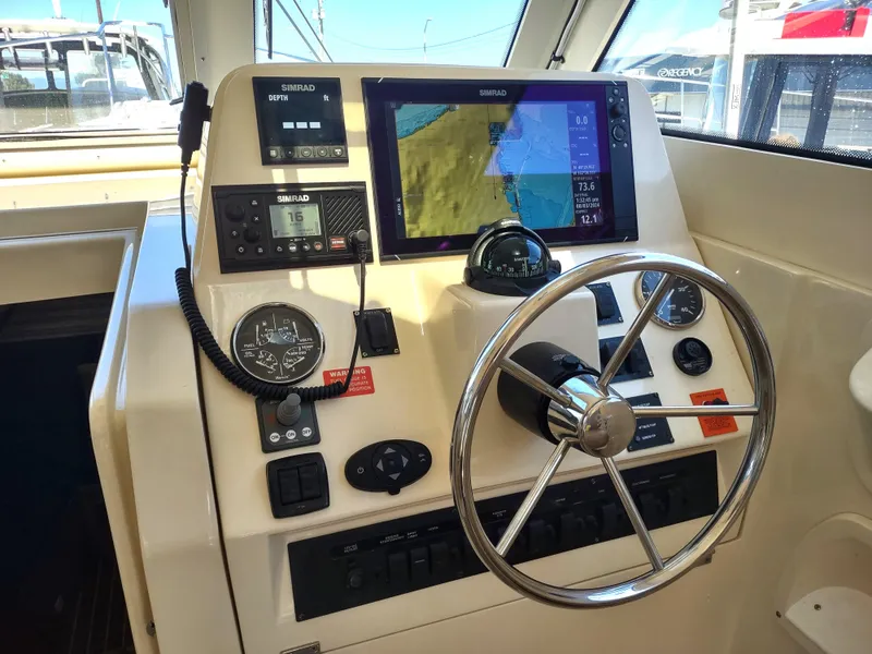 Slide: The Image of 2008 Mainship 30 Pilot II Sedan helm with navigation equipment and steering wheel. - 21