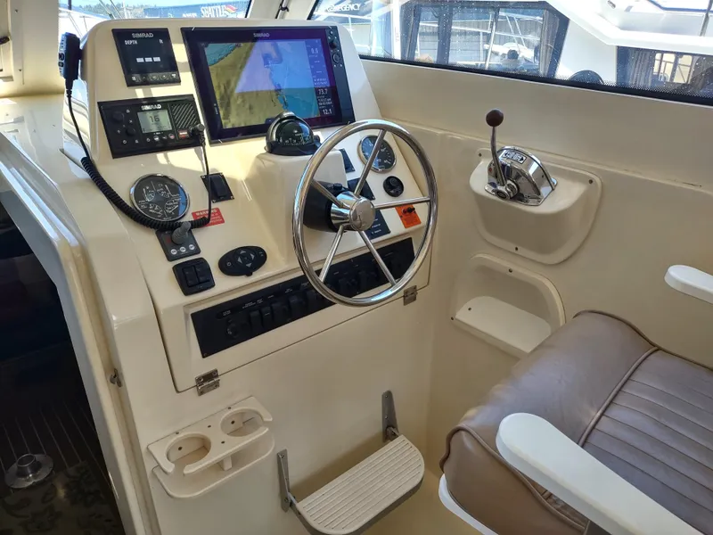 Slide: The Image of 2008 Mainship 30 Pilot II Sedan helm with navigation equipment and steering wheel. - 22