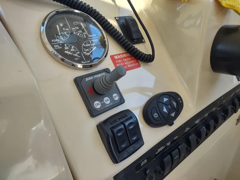 Slide: The Image of Control panel of 2008 Mainship 30 Pilot II Sedan boat with gauges and switches. - 23