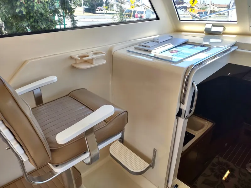 Slide: The Image of Interior helm of 2008 Mainship 30 Pilot II Sedan with captain's chair and navigation station. - 25