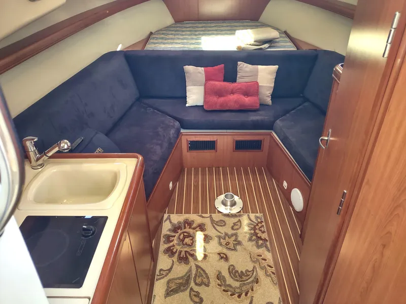 Slide: The Image of Interior of 2008 Mainship 30 Pilot II Sedan with cozy seating and kitchenette. - 27