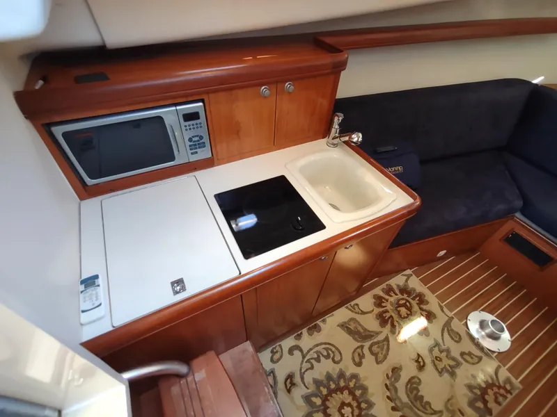 Slide: The Image of 2008 Mainship 30 Pilot II Sedan interior with kitchenette and seating area. - 30