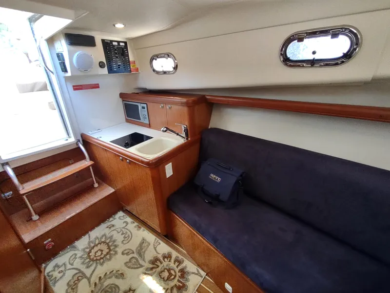 Slide: The Image of Interior of 2008 Mainship 30 Pilot II Sedan with kitchenette and seating area. - 34