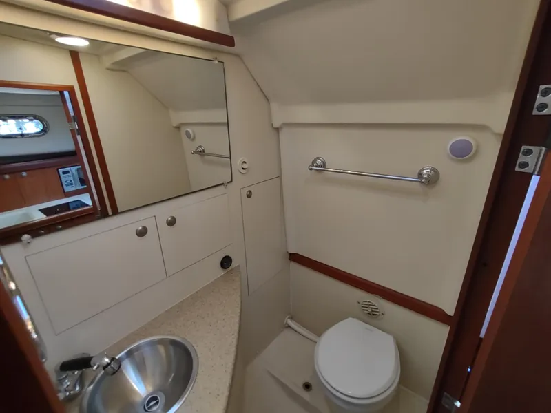Slide: The Image of 2008 Mainship 30 Pilot II Sedan bathroom with sink, mirror, and toilet. - 36