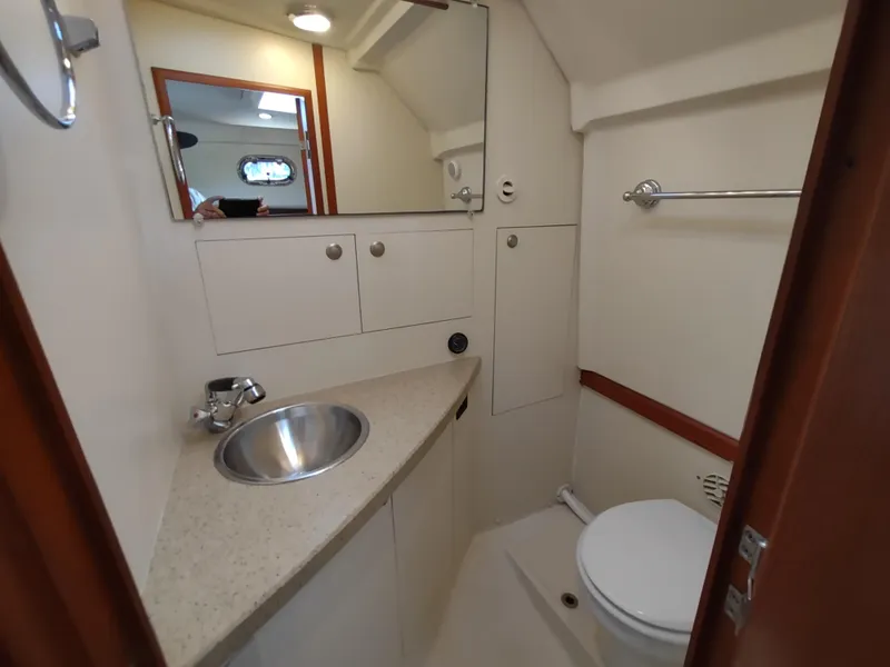 Slide: The Image of 2008 Mainship 30 Pilot II Sedan bathroom with sink, mirror, and toilet. - 37
