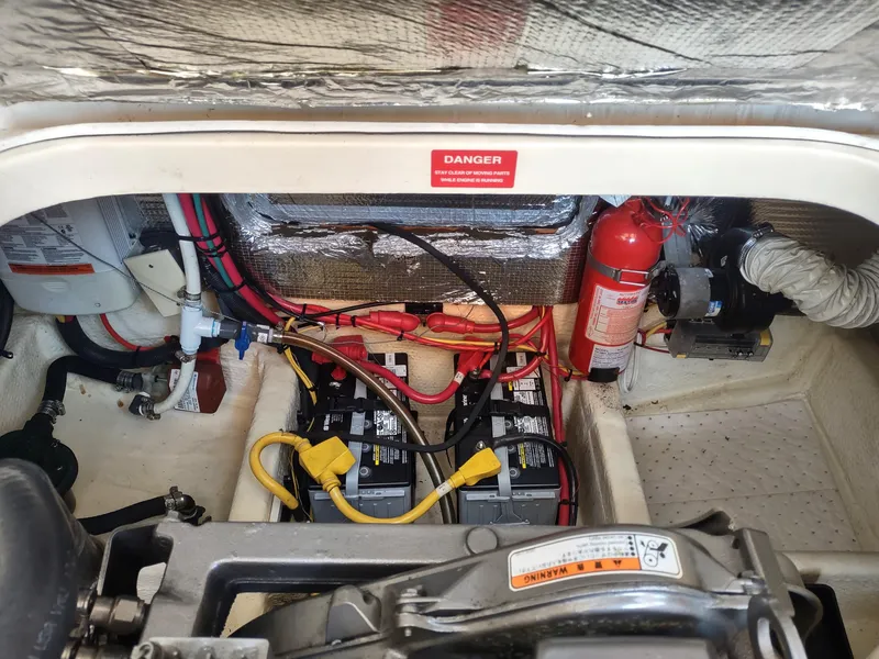Slide: The Image of Engine compartment of 2008 Mainship 30 Pilot II Sedan with batteries and fire extinguisher. - 41