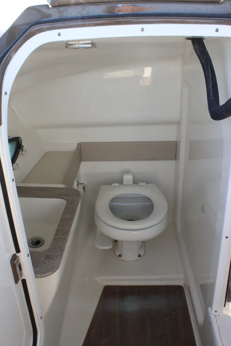 Slide: The Image of 2019 Formula 270 Bowrider boat bathroom interior with toilet and sink. - 12