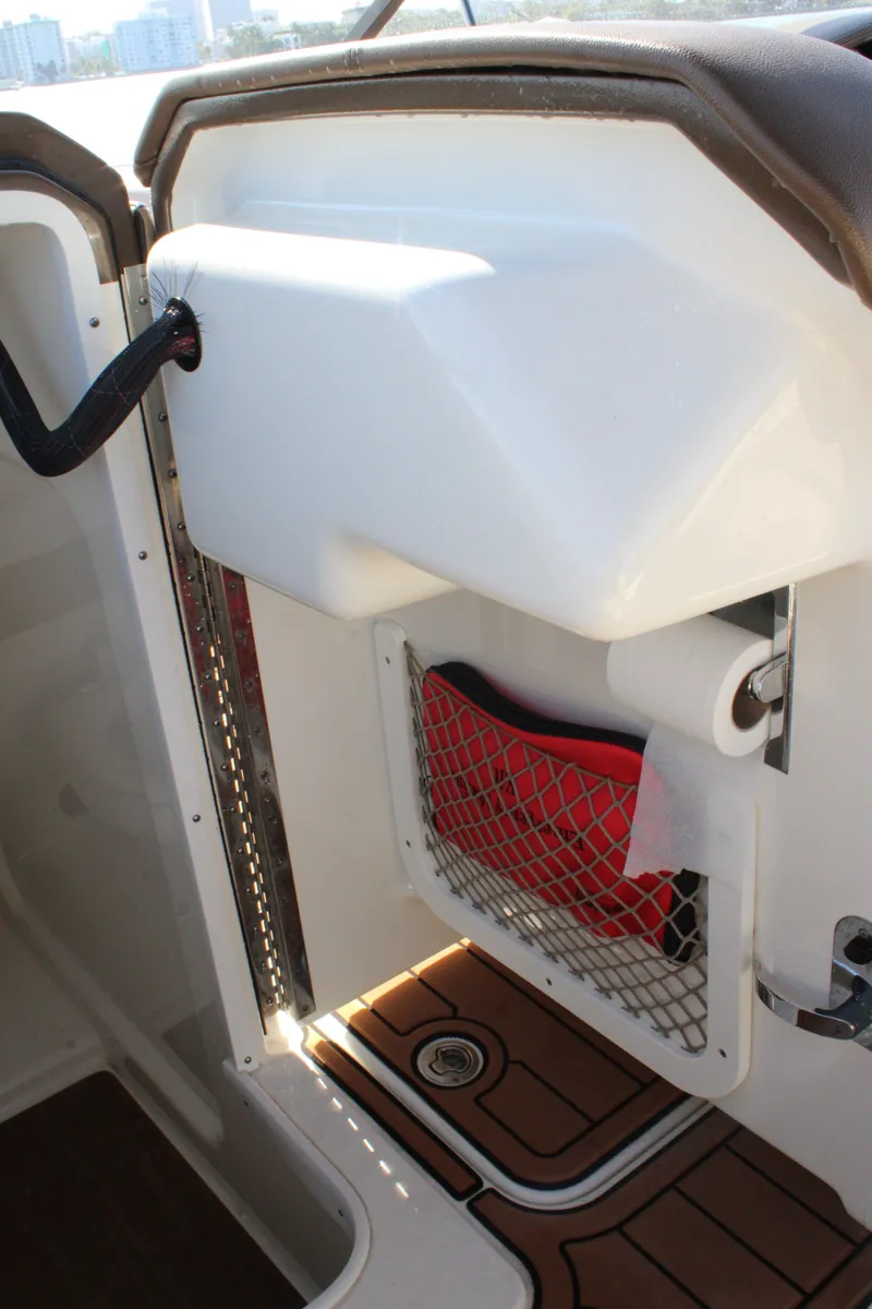 Slide: The Image of 2019 Formula 270 Bowrider interior storage compartment with netting and wood flooring. - 13