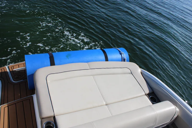 Slide: The Image of 2019 Formula 270 Bowrider boat with cushioned seating and blue float on deck. - 14