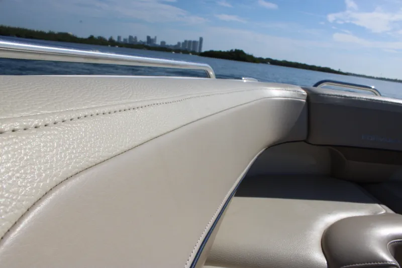 Slide: The Image of 2019 Formula 270 Bowrider interior with beige leather seating, scenic water view. - 17