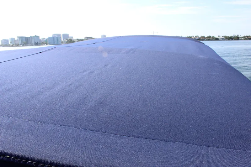 Slide: The Image of 2019 Formula 270 Bowrider boat with blue cover on water. - 19