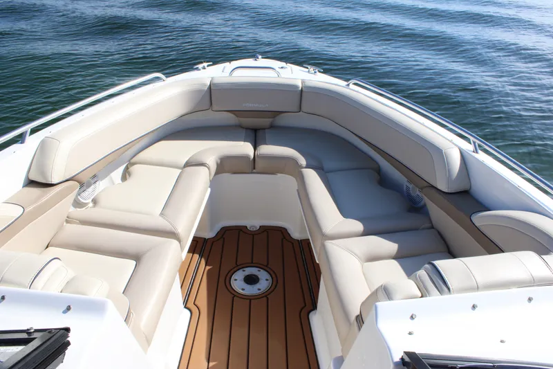 Slide: The Image of 2019 Formula 270 Bowrider boat interior with cushioned seating and teak flooring on water. - 22