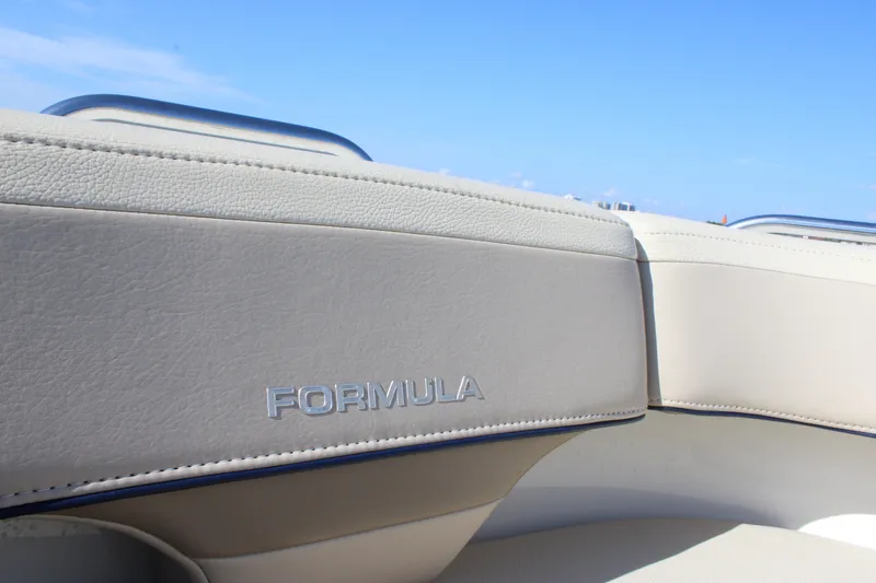 Slide: The Image of 2019 Formula 270 Bowrider interior with logo, featuring beige upholstery and blue sky background. - 5