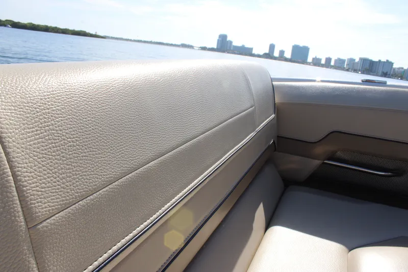 Slide: The Image of 2019 Formula 270 Bowrider interior with beige leather seating, city skyline in background. - 6