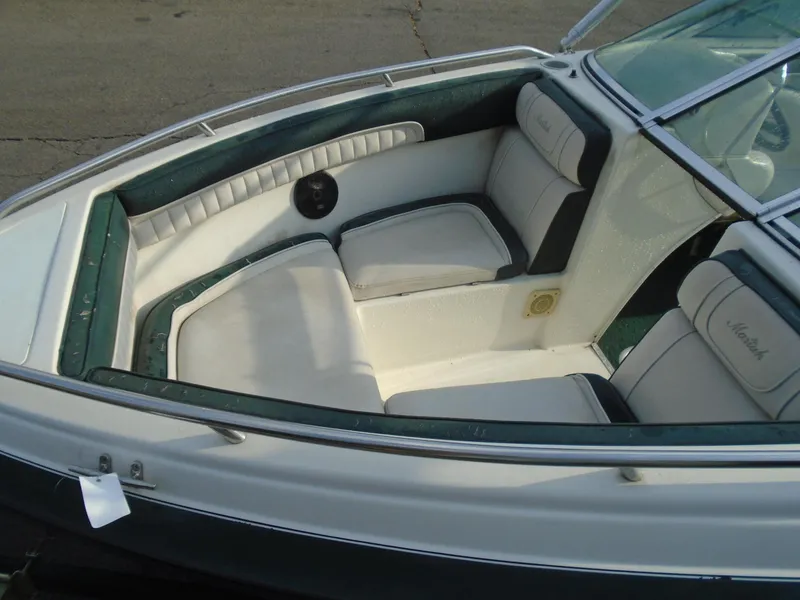 Slide: The Image of 1994 Mariah 211 Shabah boat interior with white and green seating. - 4