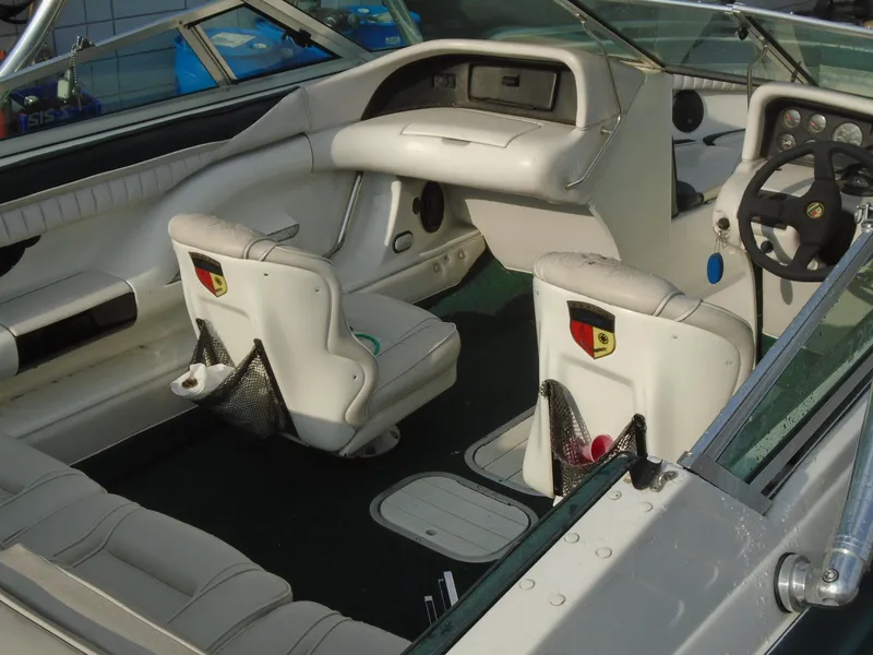Slide: The Image of Interior of a 1994 Mariah 211 Shabah boat with white seating and dashboard. - 5