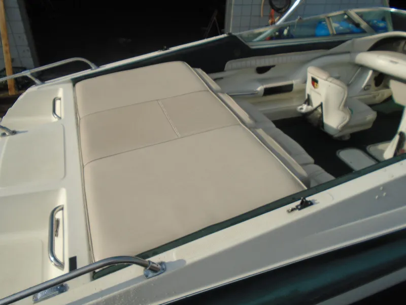 Slide: The Image of 1994 Mariah 211 Shabah boat interior with beige seating and steering console. - 6