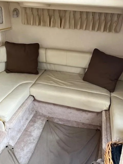 Slide: The Image of Interior of 2000 Sea Ray Cruiser 310 Sundancer with beige seating and brown cushions. - 10
