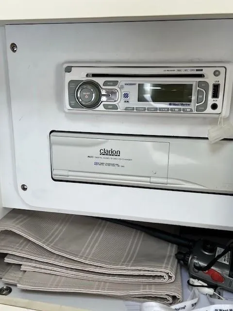 Slide: The Image of 2000 Sea Ray Cruiser 310 Sundancer stereo system with Clarion components and storage compartment. - 12