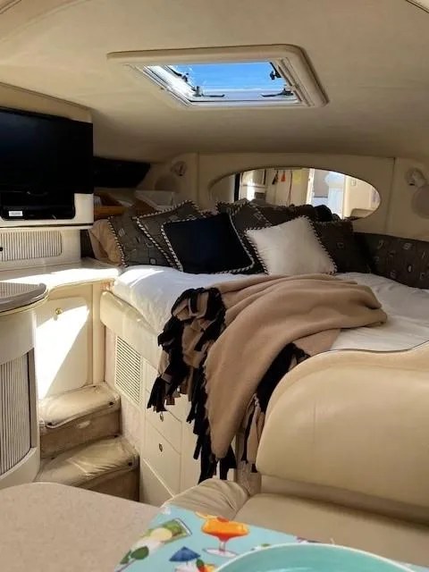 Slide: The Image of Interior of 2000 Sea Ray Cruiser 310 Sundancer with cozy bed and TV. - 14