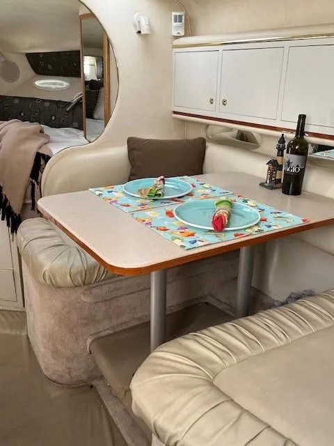 Slide: The Image of Interior of 2000 Sea Ray Cruiser 310 Sundancer with dining area setup. - 15