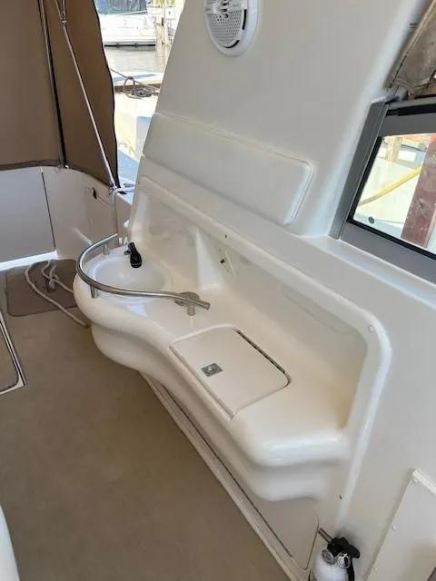 Slide: The Image of 2000 Sea Ray Cruiser 310 Sundancer interior with sink and seating area. - 16