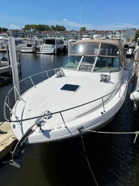 Slide: The Image of 2000 Sea Ray Cruiser 310 Sundancer docked in a marina. - 2
