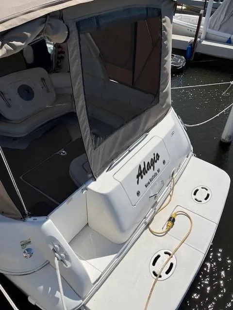 Slide: The Image of 2000 Sea Ray Cruiser 310 Sundancer docked, rear view with canopy and seating. - 23