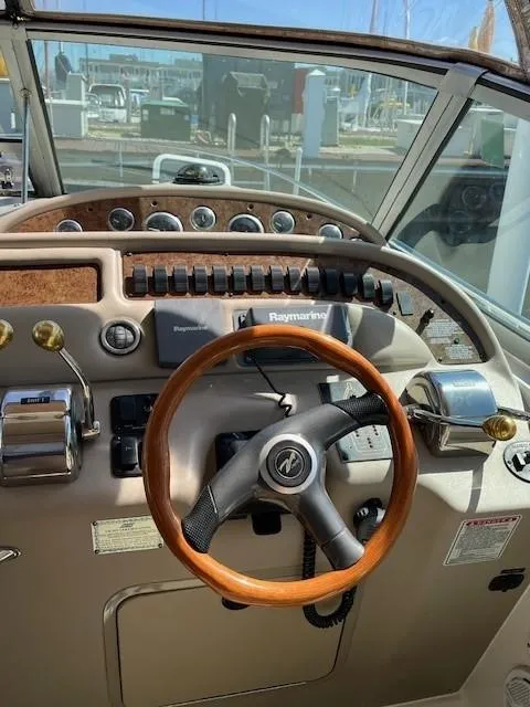 Slide: The Image of Steering wheel and controls of 2000 Sea Ray Cruiser 310 Sundancer boat. - 3