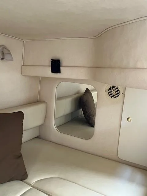 Slide: The Image of Interior cabin of 2000 Sea Ray Cruiser 310 Sundancer with beige upholstery and mirror. - 9