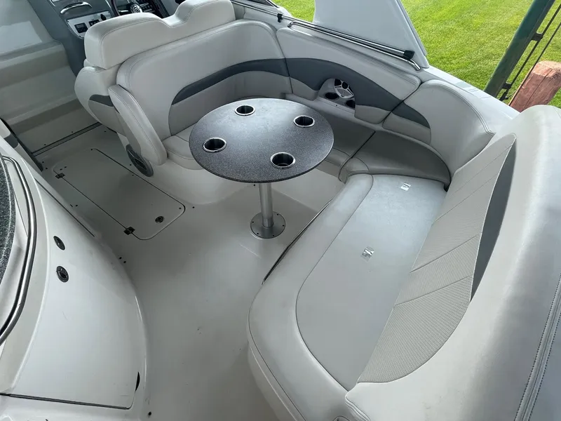 Slide: The Image of Interior of 2010 Chaparral 275 SSi boat with gray seating and round table. - 14