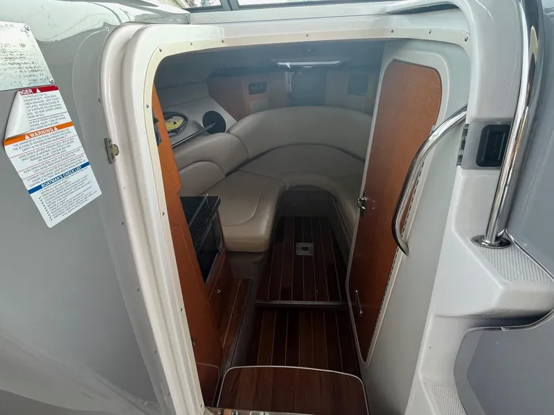 Slide: The Image of Interior cabin of 2010 Chaparral 275 SSi boat with wood flooring and seating. - 23
