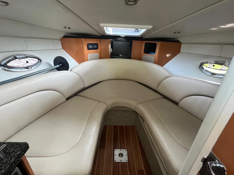Slide: The Image of Interior of 2010 Chaparral 275 SSi boat with plush seating and wood flooring. - 24