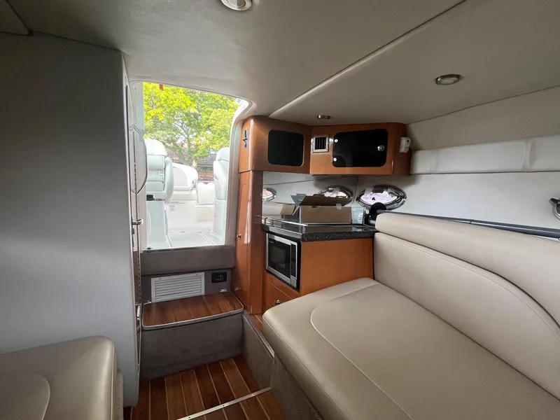 Slide: The Image of Interior of 2010 Chaparral 275 SSi boat with seating and kitchenette. - 27