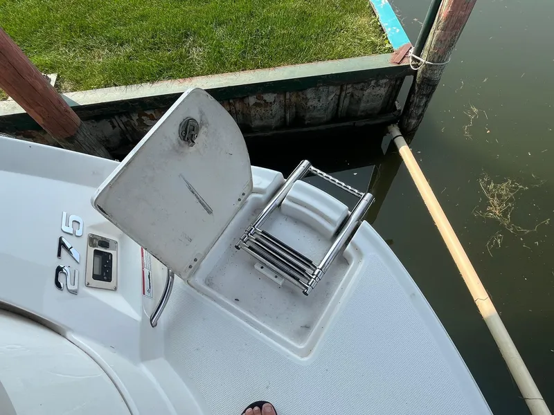 Slide: The Image of Chaparral 275 SSi 2010 boat with open hatch and ladder near dock. - 5