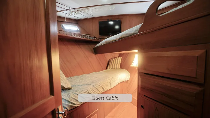 Slide: The Image of Guest cabin in 1988 DeFever Pilot House yacht with wooden interior and bunk beds. - 15