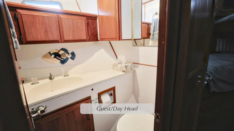 Slide: The Image of 1988 DeFever Pilot House guest bathroom with wooden cabinets and modern fixtures. - 16